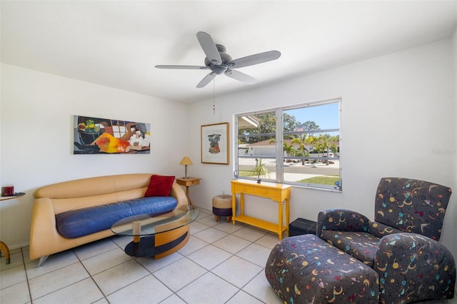 sitting room with tile patterned flooring and a ceiling fan