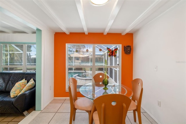 dining area featuring beam ceiling, light tile patterned floors, and baseboards