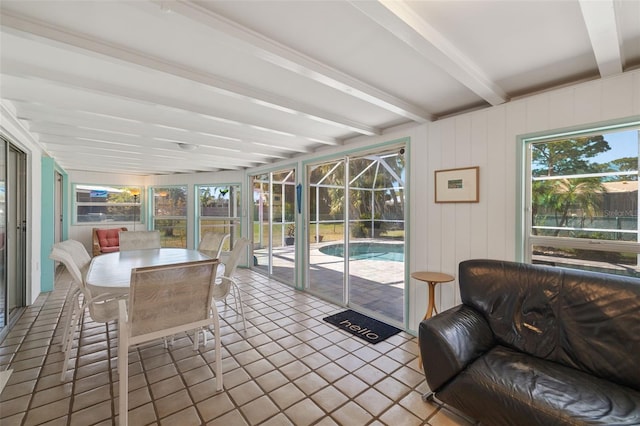 sunroom / solarium with beamed ceiling and a healthy amount of sunlight