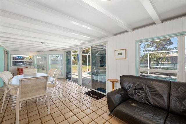 sunroom / solarium with beamed ceiling and a healthy amount of sunlight