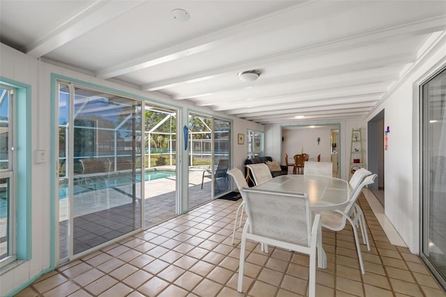 sunroom featuring beam ceiling