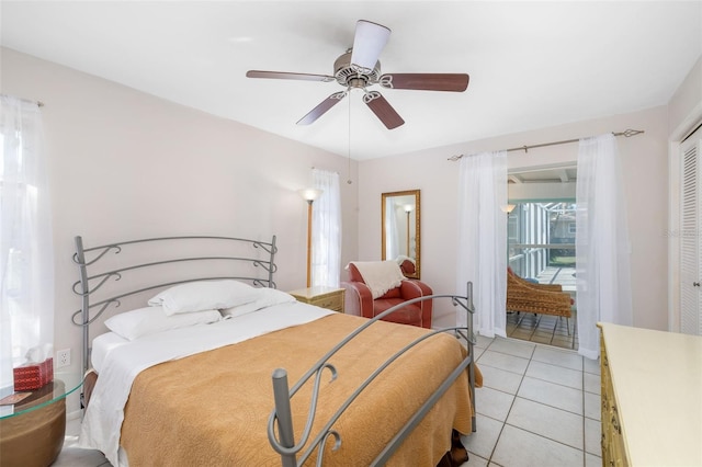 bedroom featuring light tile patterned flooring, a closet, and ceiling fan