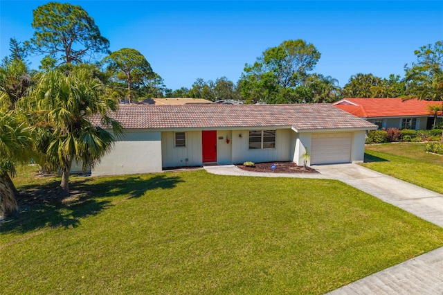 ranch-style home featuring a tiled roof, an attached garage, driveway, and a front yard