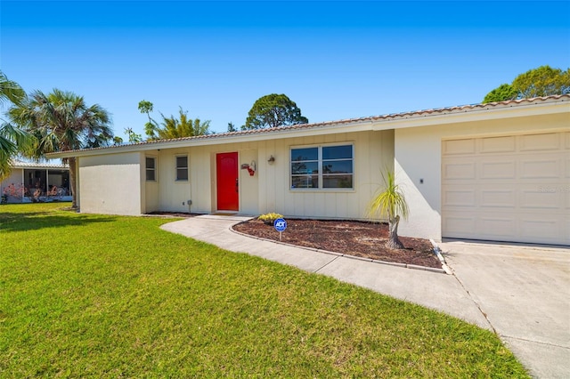 ranch-style house featuring an attached garage and a front lawn