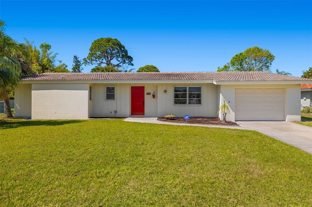 ranch-style house with a front lawn, concrete driveway, an attached garage, and a tiled roof