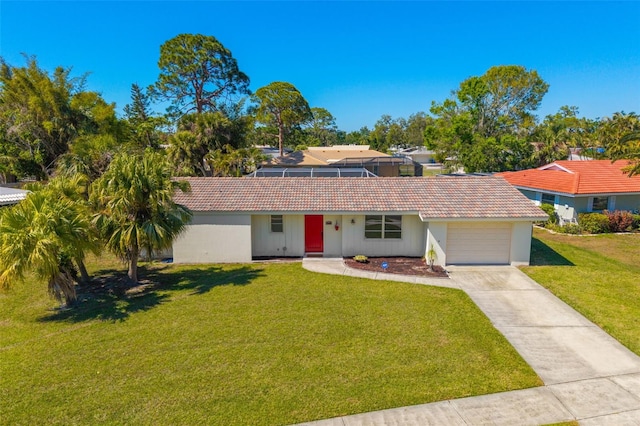 ranch-style home featuring a tiled roof, a garage, driveway, and a front yard