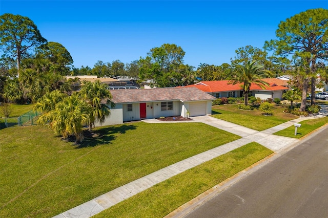 single story home with fence, concrete driveway, a front yard, stucco siding, and a garage