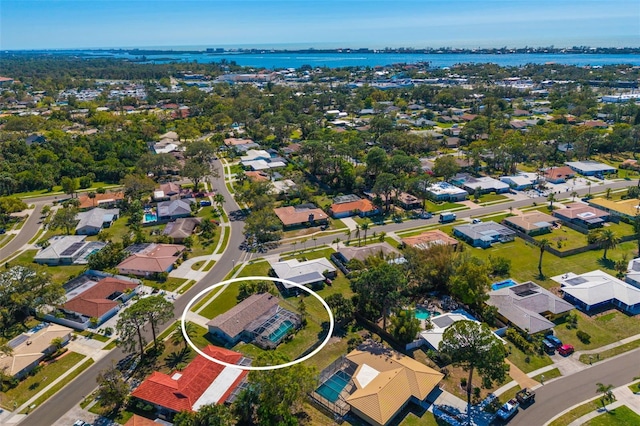 birds eye view of property with a water view and a residential view