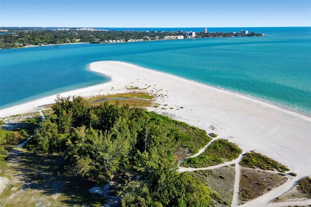 birds eye view of property featuring a view of the beach and a water view