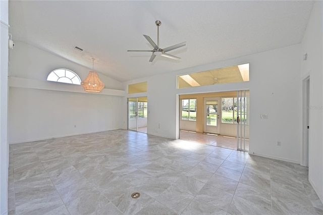spare room featuring baseboards, a ceiling fan, visible vents, and high vaulted ceiling