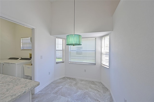 dining space with baseboards and washing machine and dryer
