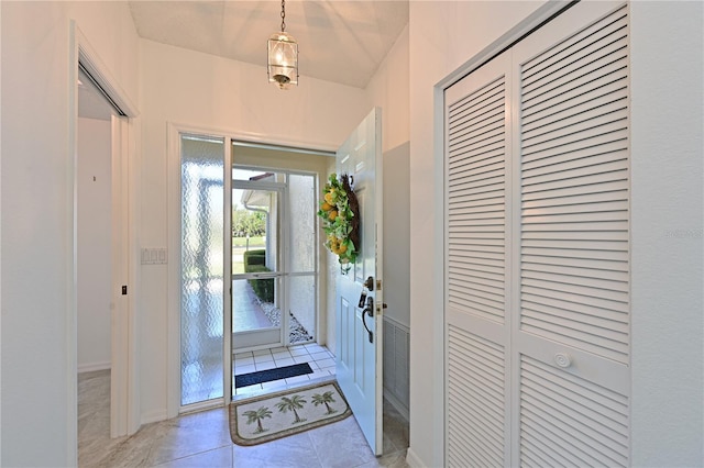 foyer entrance with light tile patterned floors