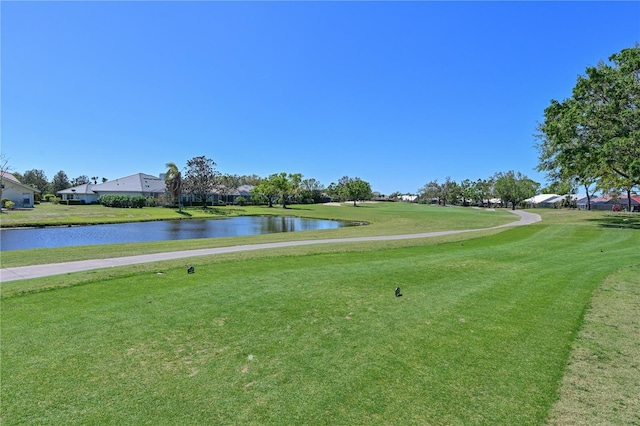 surrounding community with a yard and a water view