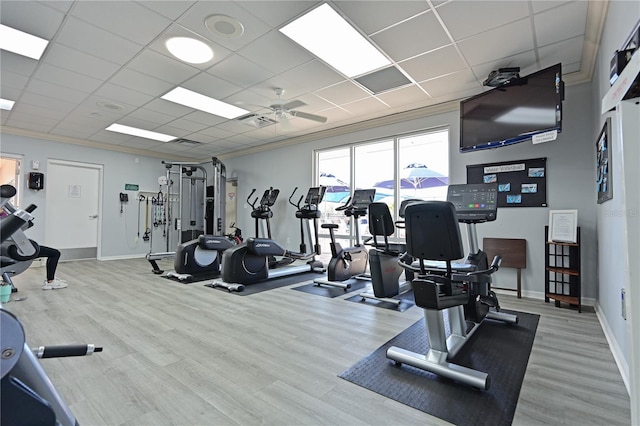 gym with ornamental molding, wood finished floors, and ceiling fan