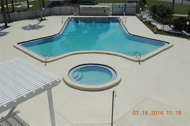 pool featuring a patio and fence