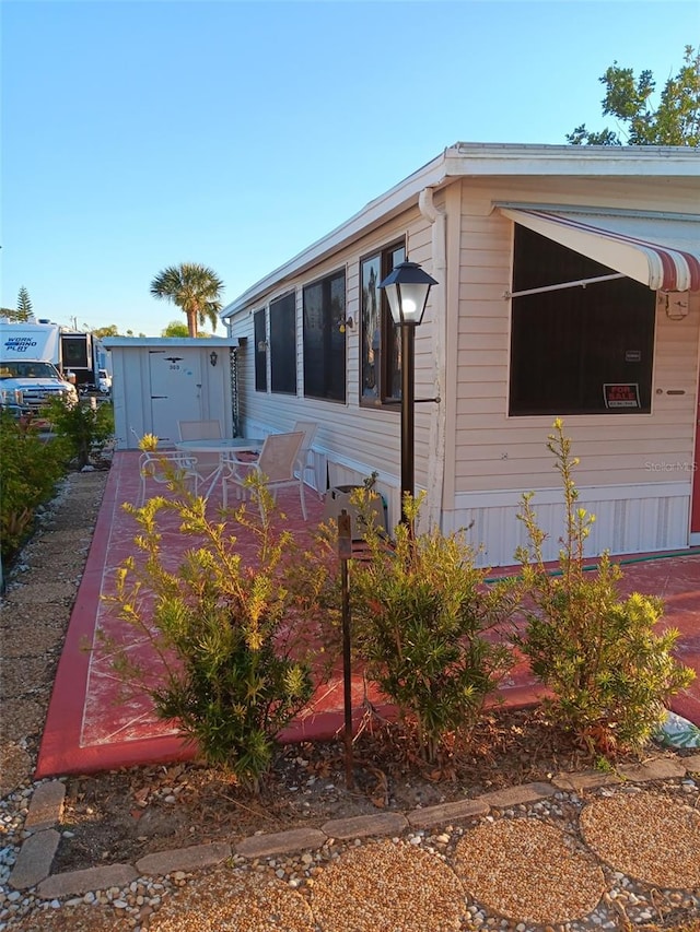 view of side of property with an outdoor structure