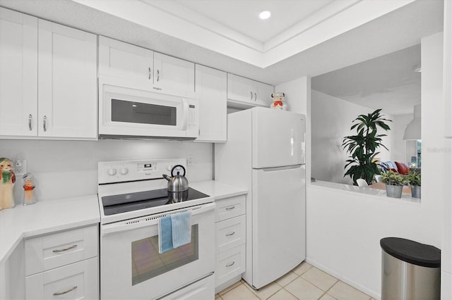 kitchen featuring white appliances, light tile patterned flooring, decorative backsplash, light countertops, and white cabinetry