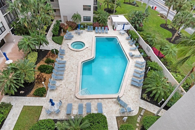 pool with a hot tub and a patio