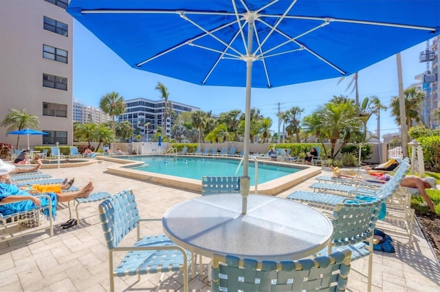 pool with a patio and fence