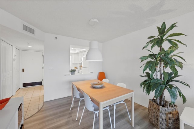 dining room with visible vents and light wood-type flooring