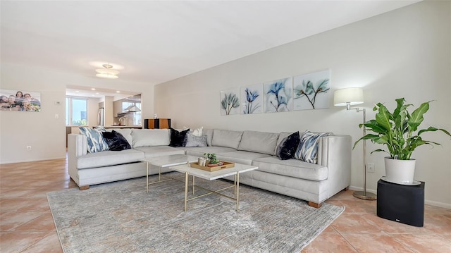 living room featuring baseboards and light tile patterned flooring