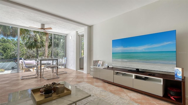 unfurnished living room with ceiling fan, expansive windows, and light tile patterned flooring