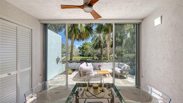 sunroom with a ceiling fan