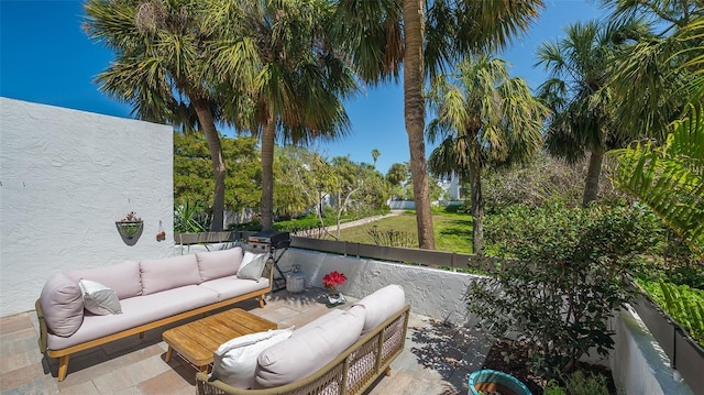 view of patio / terrace with grilling area, an outdoor hangout area, and fence