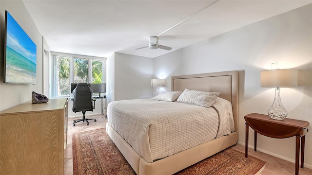 bedroom with light tile patterned floors, baseboards, and ceiling fan