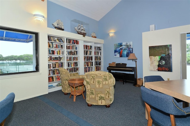 sitting room with baseboards, high vaulted ceiling, and carpet