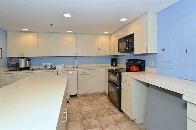 kitchen featuring a sink, black appliances, recessed lighting, and light countertops