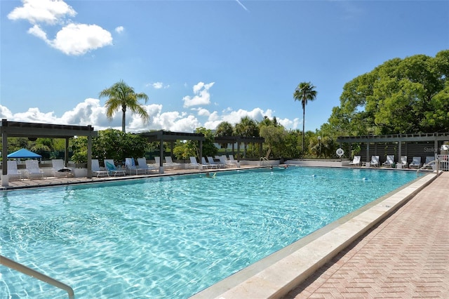 pool featuring a pergola and a patio area