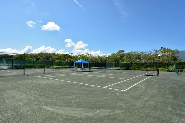 view of sport court featuring fence