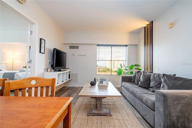 living room featuring visible vents and wood finished floors