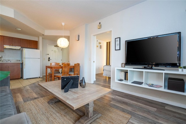 living room with baseboards and light wood finished floors