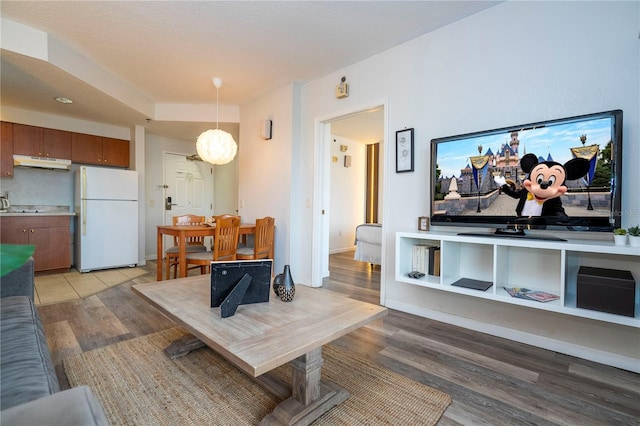 living area featuring light wood-type flooring and baseboards