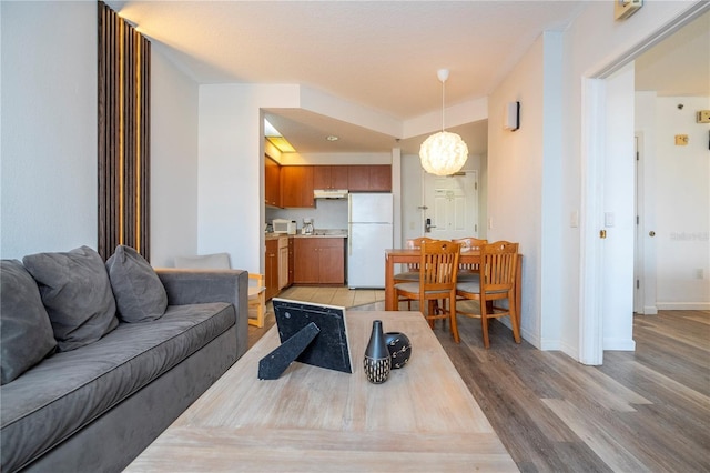 living room with baseboards and light wood-style floors