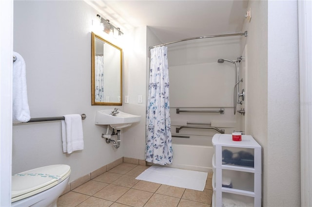 full bathroom featuring toilet, a sink, shower / bath combination with curtain, baseboards, and tile patterned flooring