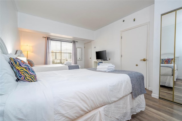 bedroom featuring a closet and wood finished floors