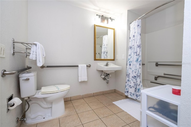 bathroom with tile patterned floors, toilet, and baseboards