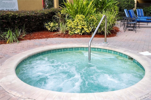 view of swimming pool featuring a patio area and a community hot tub