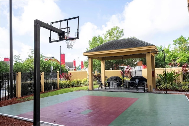 view of basketball court with a gazebo, community basketball court, and fence