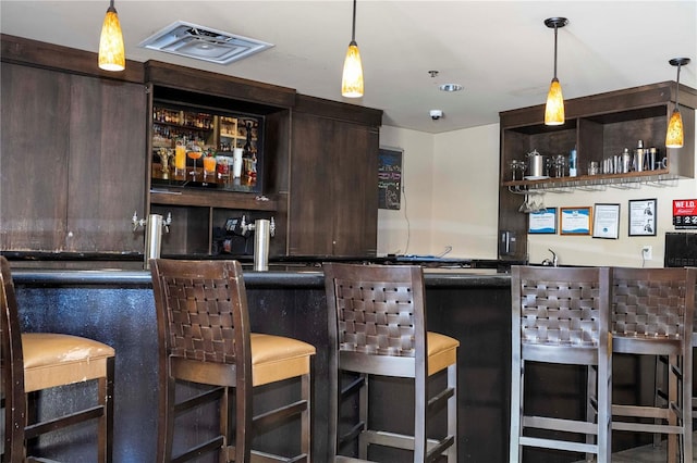 bar with pendant lighting and wet bar