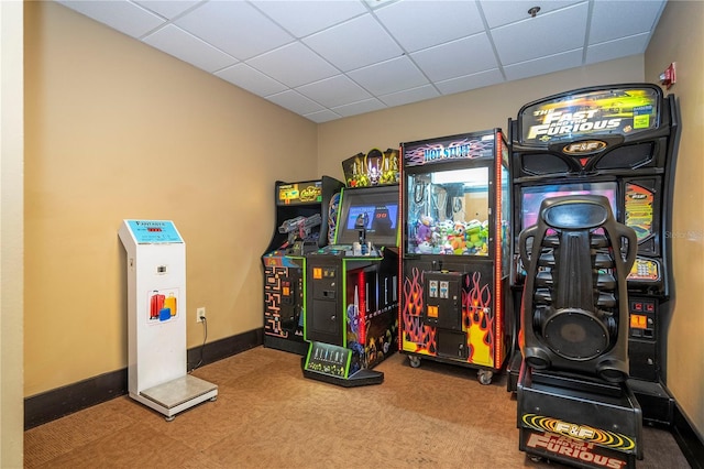 rec room featuring a drop ceiling, carpet flooring, and baseboards