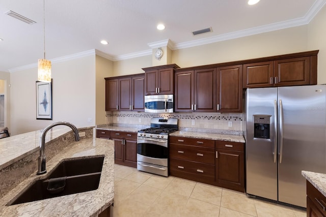 kitchen featuring a sink, visible vents, appliances with stainless steel finishes, and decorative backsplash