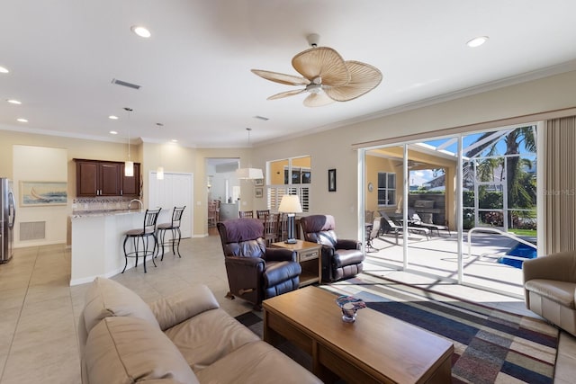 living room featuring recessed lighting, visible vents, and ornamental molding