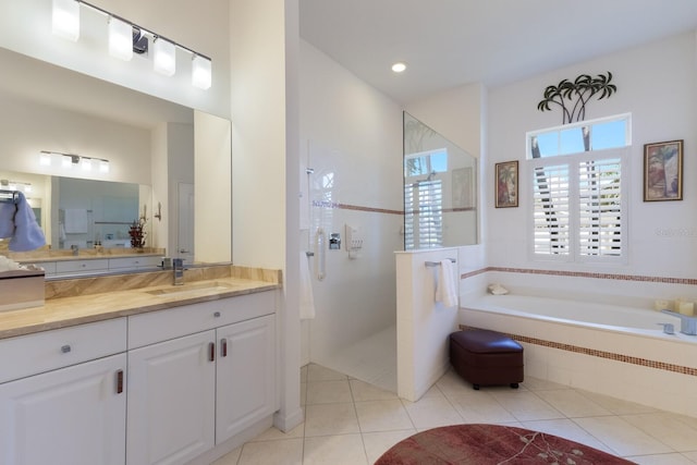 bathroom featuring walk in shower, a bath, vanity, and tile patterned flooring