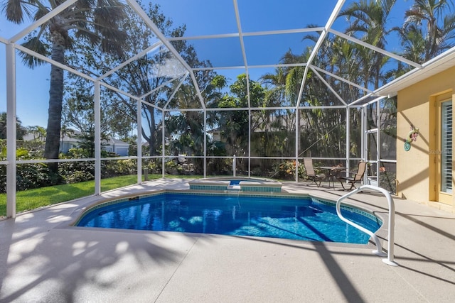 view of pool featuring glass enclosure, a pool with connected hot tub, and a patio