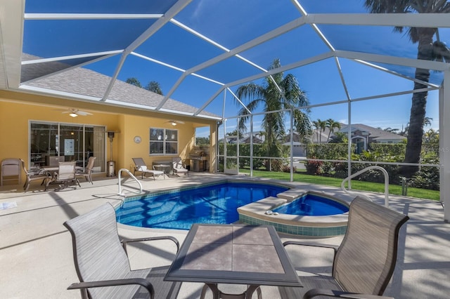 view of pool featuring a patio, a ceiling fan, a pool with connected hot tub, and a lanai