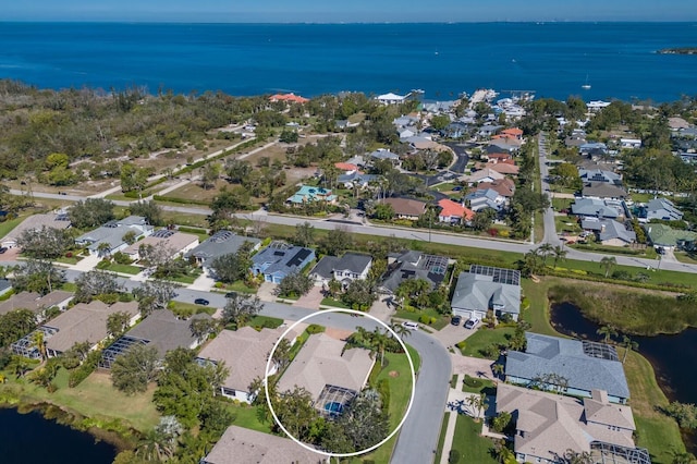 birds eye view of property with a residential view and a water view